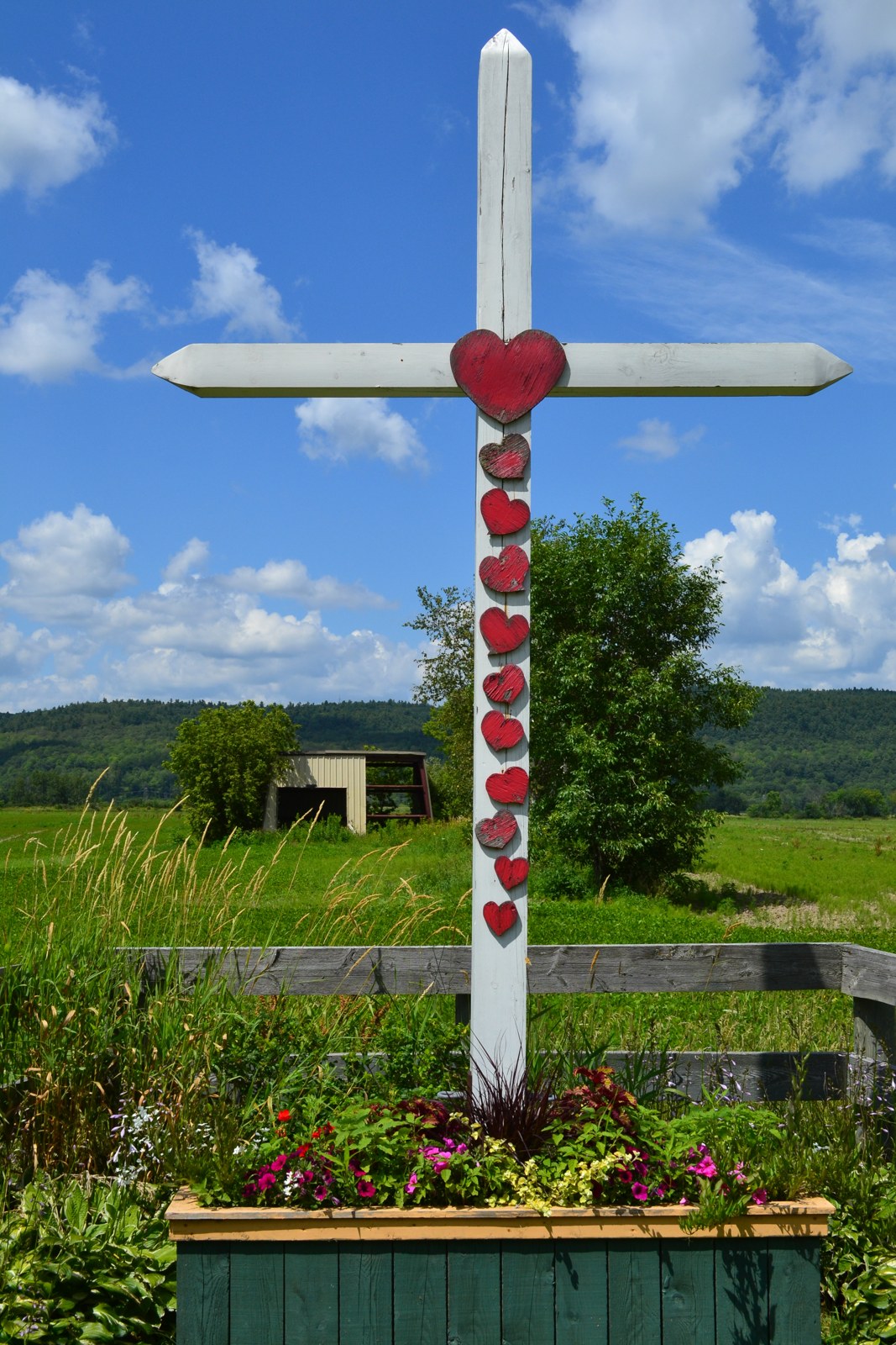 Croix de chemin blanche ornée de cœurs rouges à Fassett